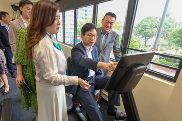 The Secretary for Labour and Welfare, Mr Chris Sun, today (July 12) visited To Kwa Wan Community Living Room. The Permanent Secretary for Labour and Welfare, Ms Alice Lau; and the Director of Social Welfare, Miss Charmaine Lee, also attended. Photo shows Mr Sun using fitness equipment in the Community Living Room.